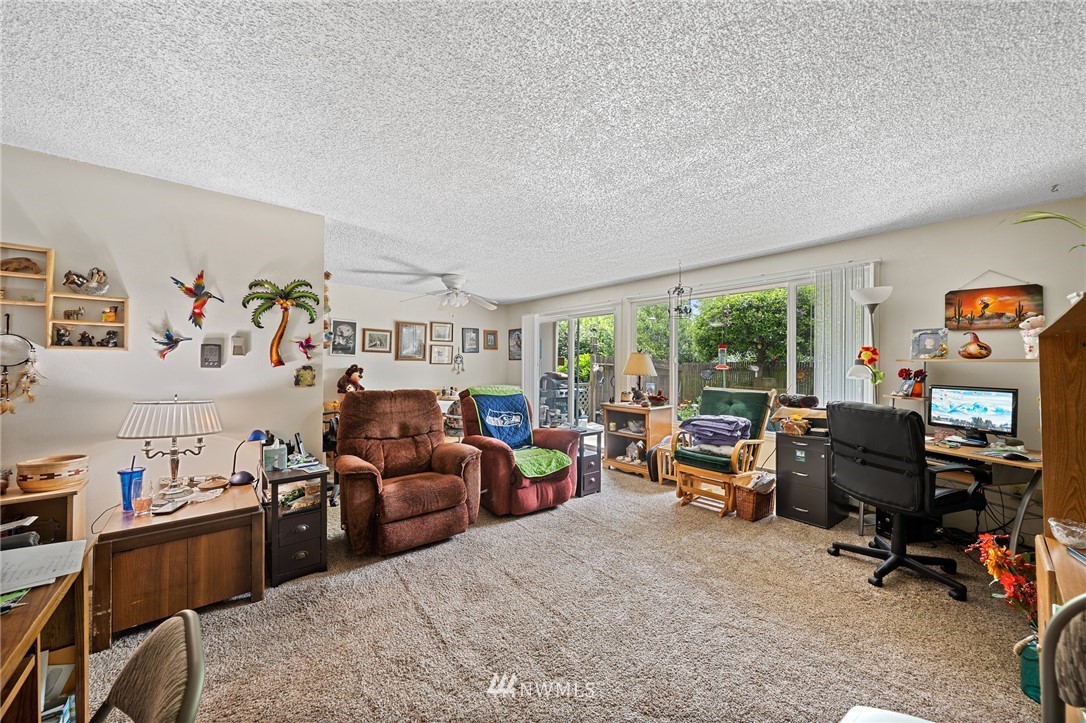 980 Edmonds Avenue Northeast Renton, WA 98056 - Photo 12 of 28 a view of a workspace with furniture and a livingroom