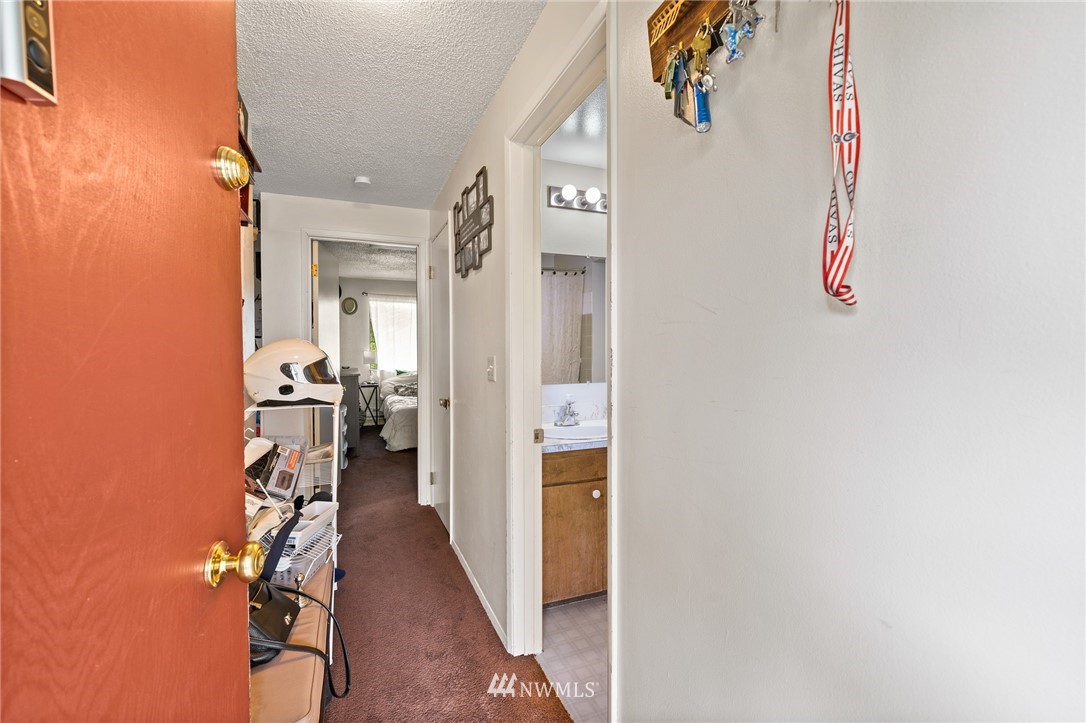 980 Edmonds Avenue Northeast Renton, WA 98056 - Photo 17 of 28 a view of a hallway with wooden floor and a living room