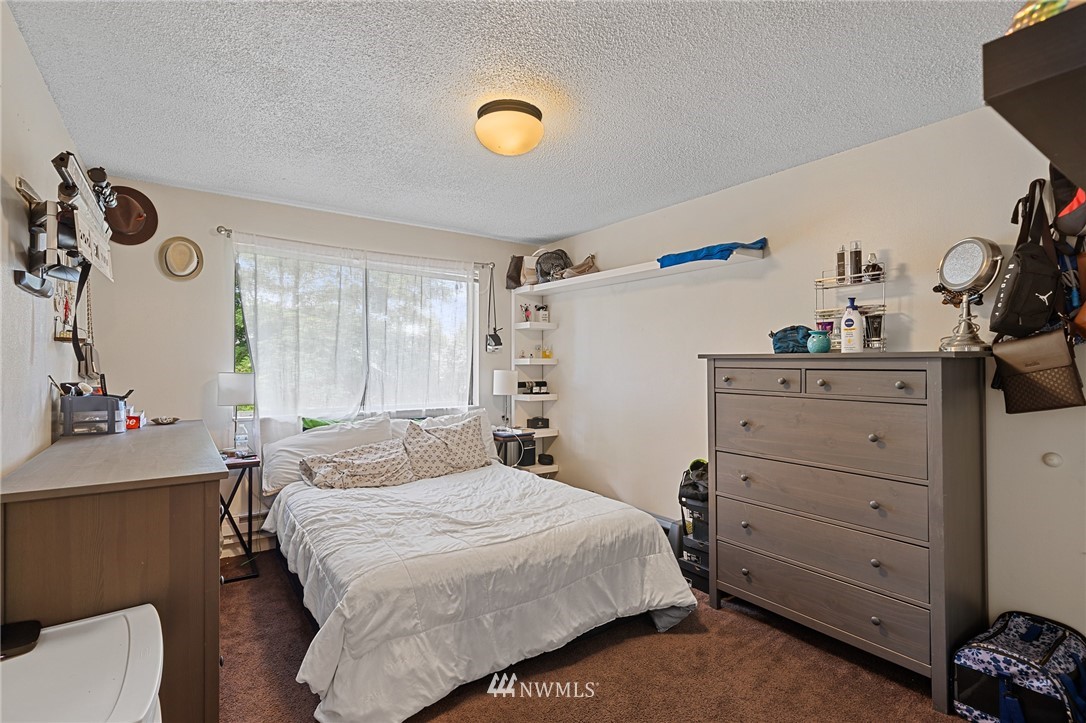 980 Edmonds Avenue Northeast Renton, WA 98056 - Photo 19 of 28 a bedroom with a bed and a dresser in it