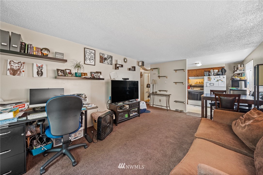 980 Edmonds Avenue Northeast Renton, WA 98056 - Photo 22 of 28 a living room with furniture and a flat screen tv