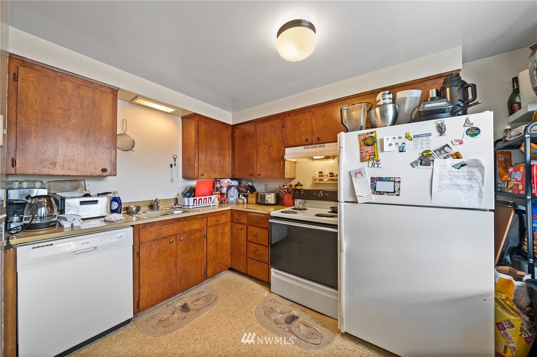 980 Edmonds Avenue Northeast Renton, WA 98056 - Photo 24 of 28 a kitchen with stainless steel appliances a refrigerator sink and cabinets