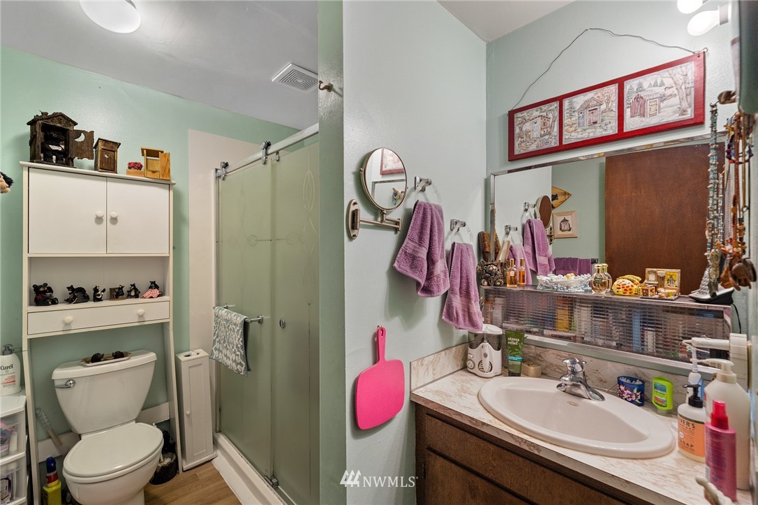 980 Edmonds Avenue Northeast Renton, WA 98056 - Photo 5 of 28 a bathroom with a sink vanity mirror and toilet
