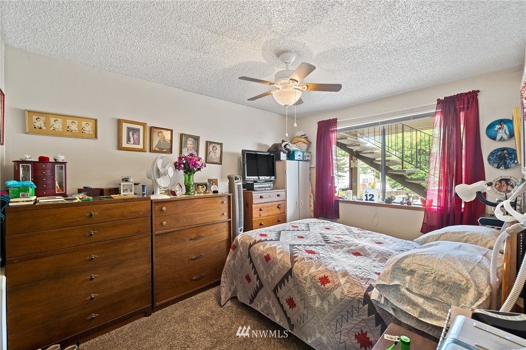 980 Edmonds Avenue Northeast Renton, WA 98056 - Photo 6 of 28 a bedroom with a bed and a large window
