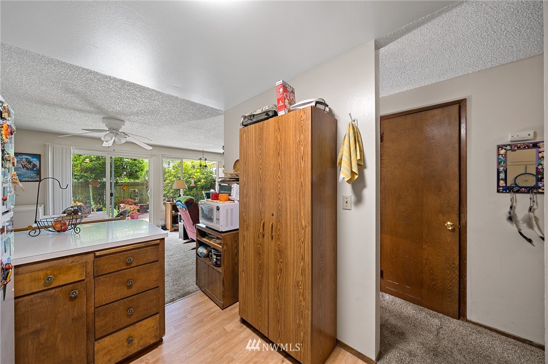980 Edmonds Avenue Northeast Renton, WA 98056 - Photo 7 of 28 a view of a walk in closet and living room