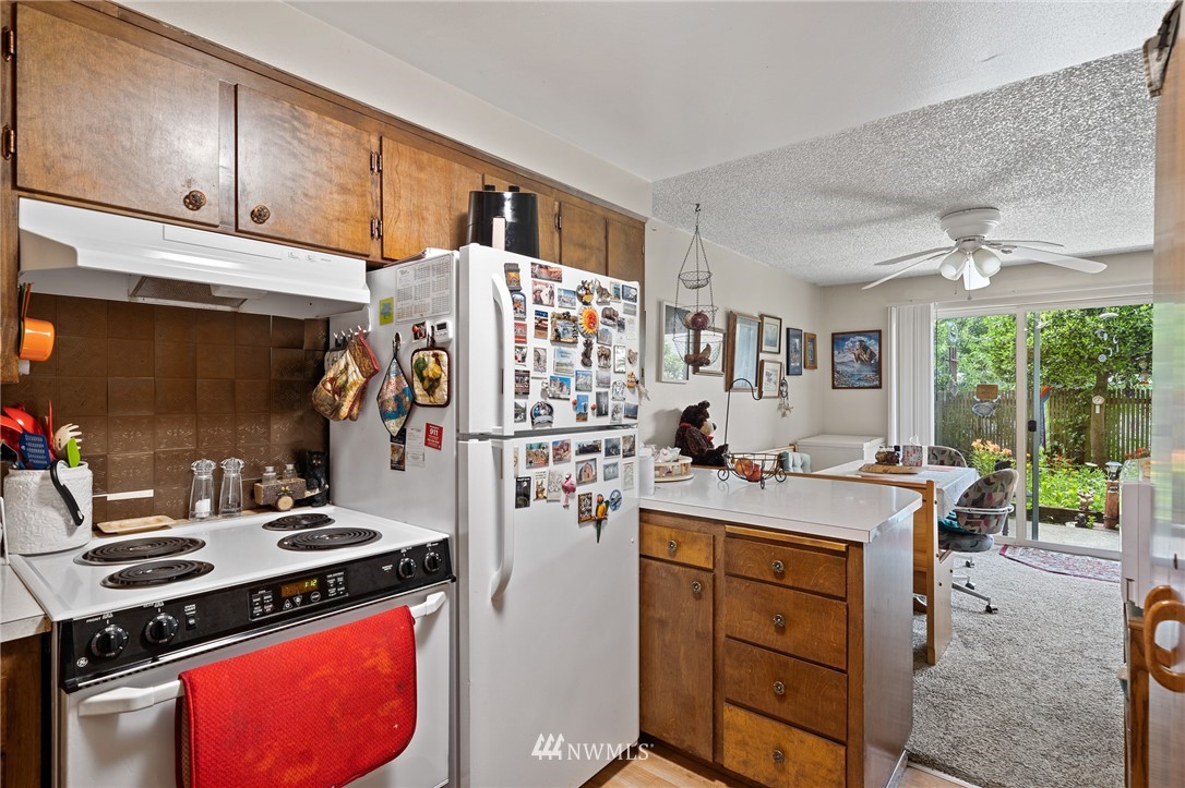 980 Edmonds Avenue Northeast Renton, WA 98056 - Photo 8 of 28 a kitchen with a stove and a refrigerator