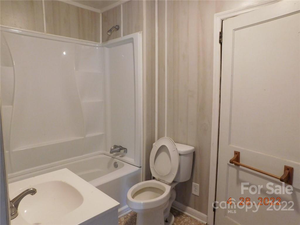 3118 Austin Chaney Road Monroe, NC 28110 - Photo 12 of 15 a bathroom with a toilet a sink and a bathtub