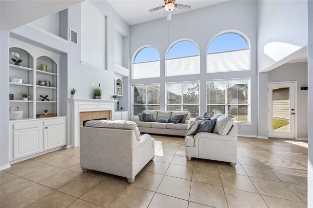 a living room with furniture and a floor to ceiling window