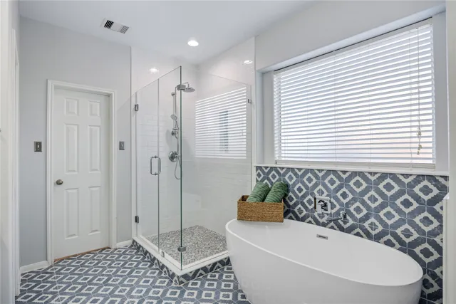 a view of an empty room with a window and a ceiling fan