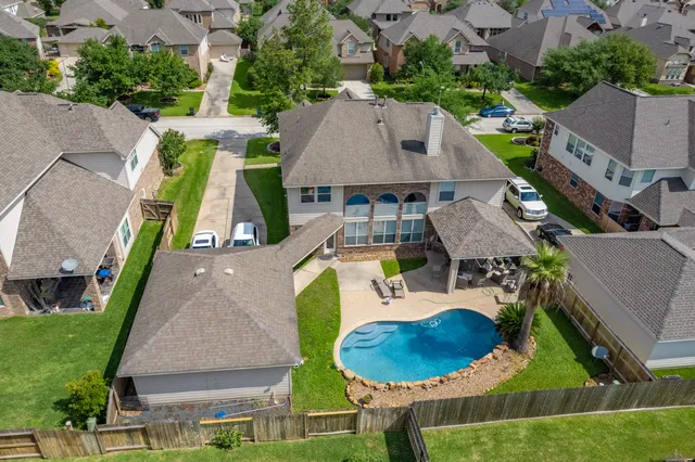 an aerial view of a house with garden space and pool view