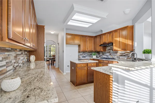 a kitchen with a stove a sink and a refrigerator