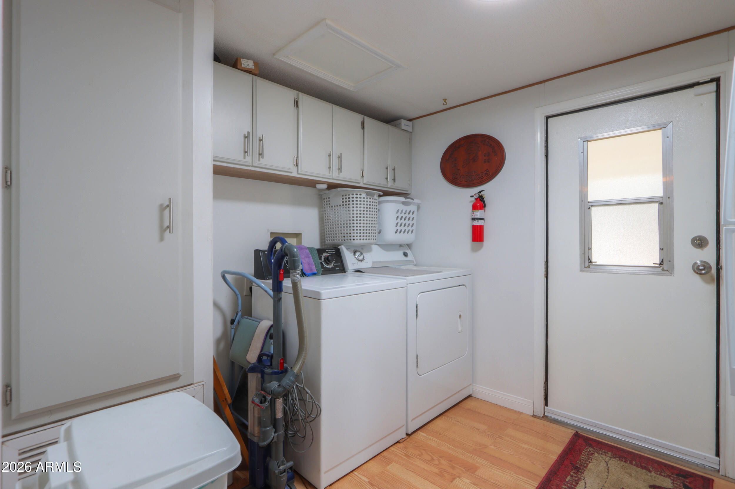 2100 North Trekell Road, Unit 290 Casa Grande, AZ 85122 - Photo 27 of 35 a storage room with wooden floor washer and dryer
