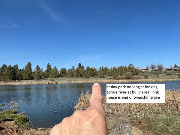 a view of a lake with houses in the back