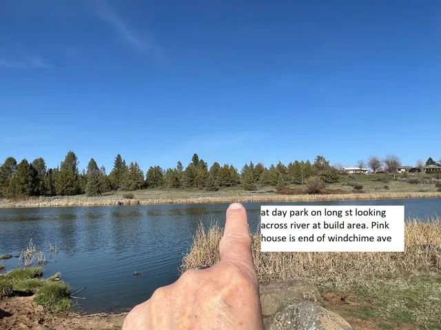 a view of a lake with houses in the back