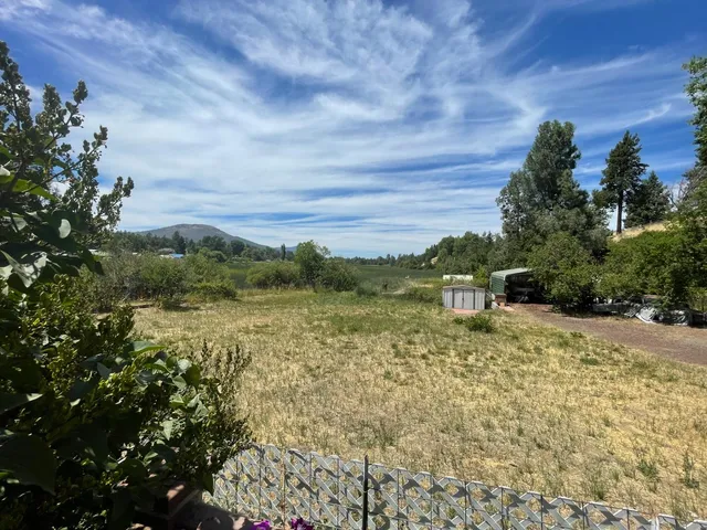 a sign board with wooden fence
