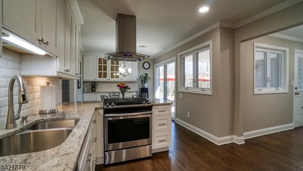 a kitchen with granite countertop a stove and a sink
