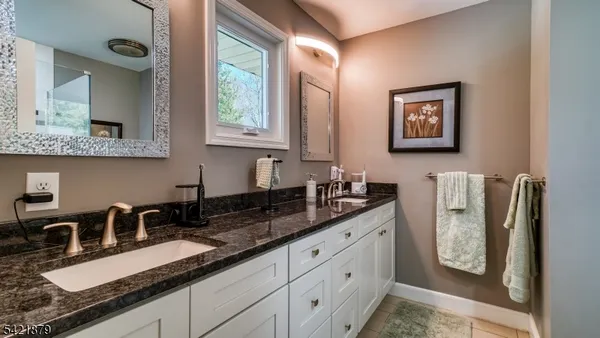 a kitchen with stainless steel appliances granite countertop a sink a stove and a granite counter top