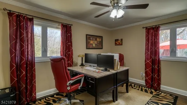 a view of a workspace with furniture and a window