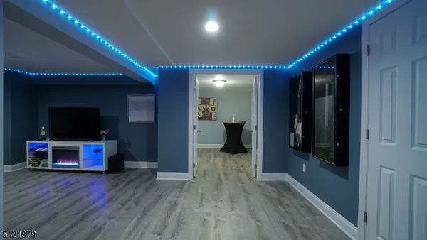 a view of a hallway with wooden floor and furniture