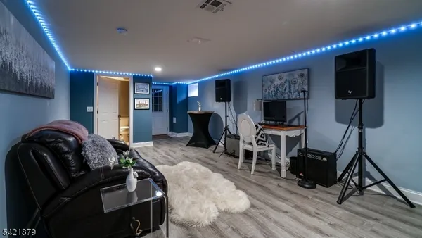 a bedroom with furniture and a flat screen tv