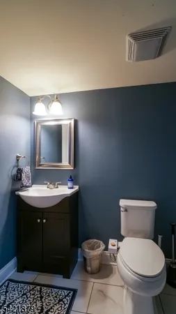 a bathroom with a sink toilet and mirror