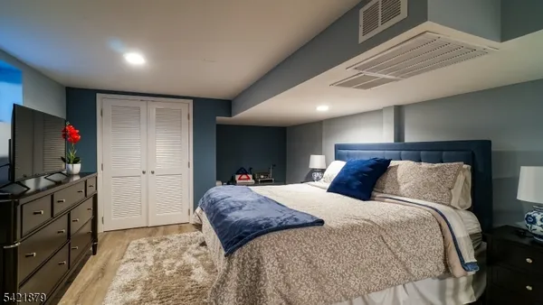 a bed room with a bed and a television