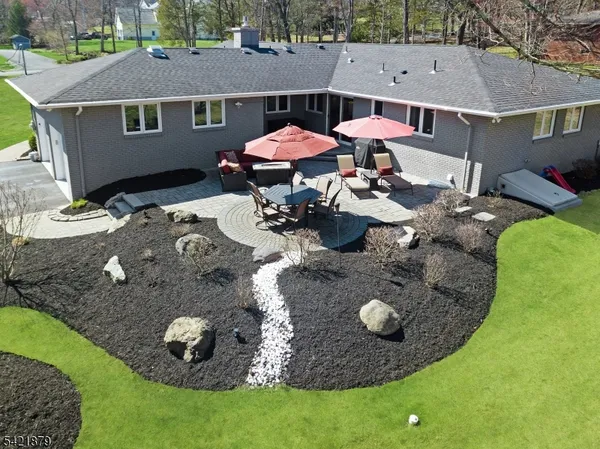 an aerial view of a house with yard and patio