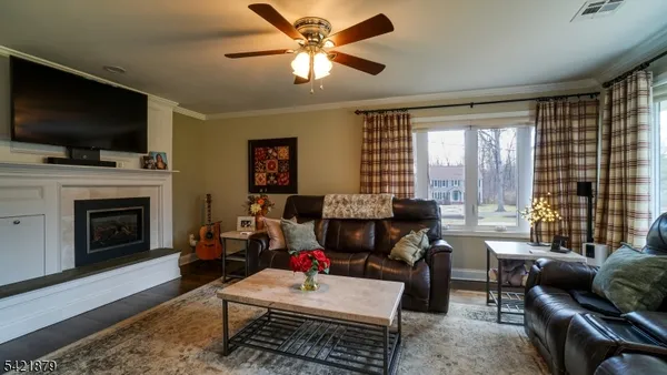 a living room with furniture fireplace and a flat screen tv