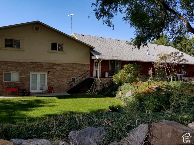 2855 South 1000 West Perry, UT 84302 - Photo 6 of 142 Back of property with a patio area, stone siding, a lawn, french doors, and stucco siding