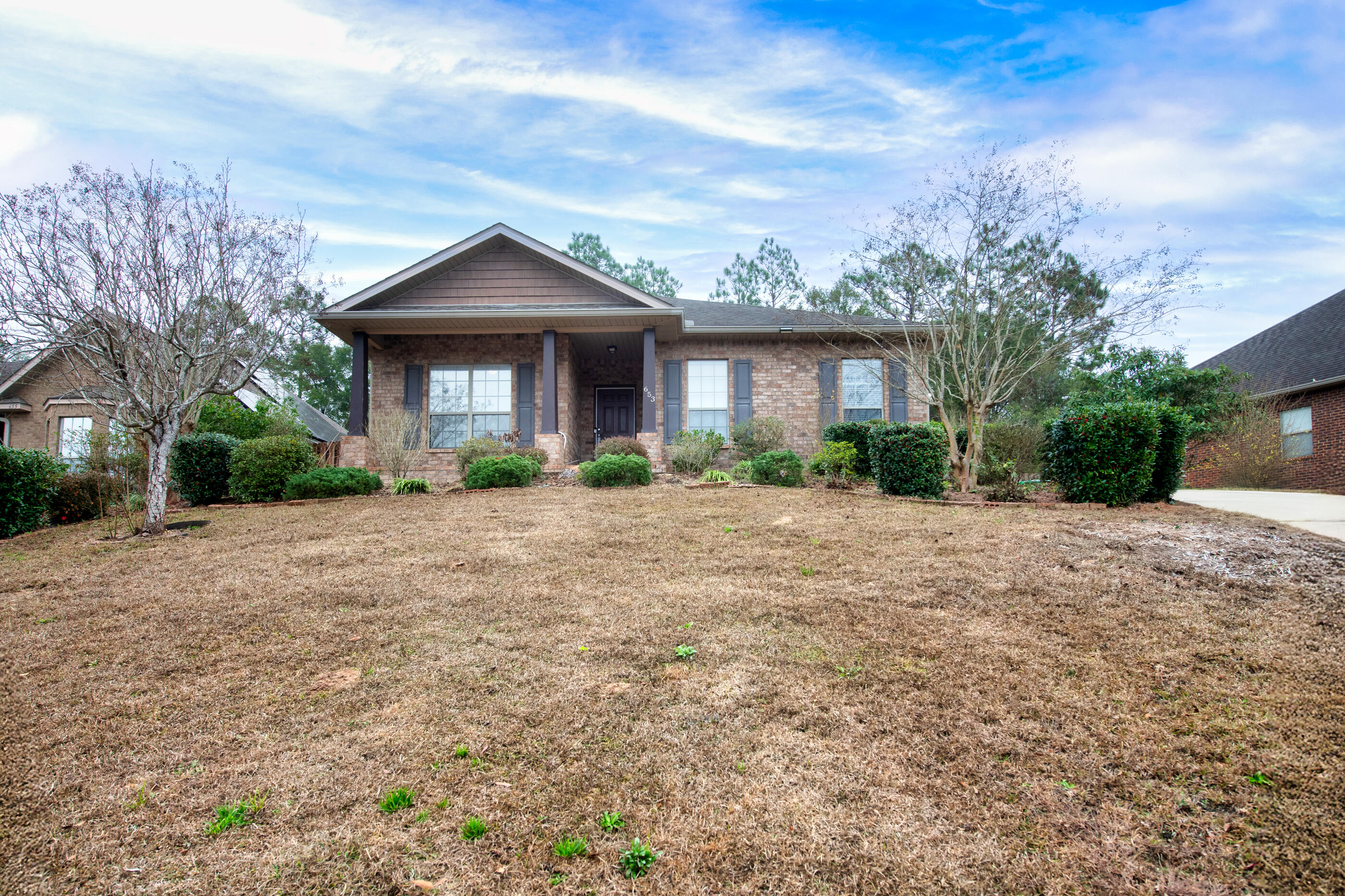 653 Red Fern Road Crestview, FL 32536 - Photo 1 of 34 a front view of a house with garden