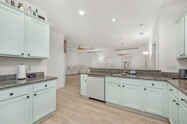 a kitchen with granite countertop a sink and cabinets