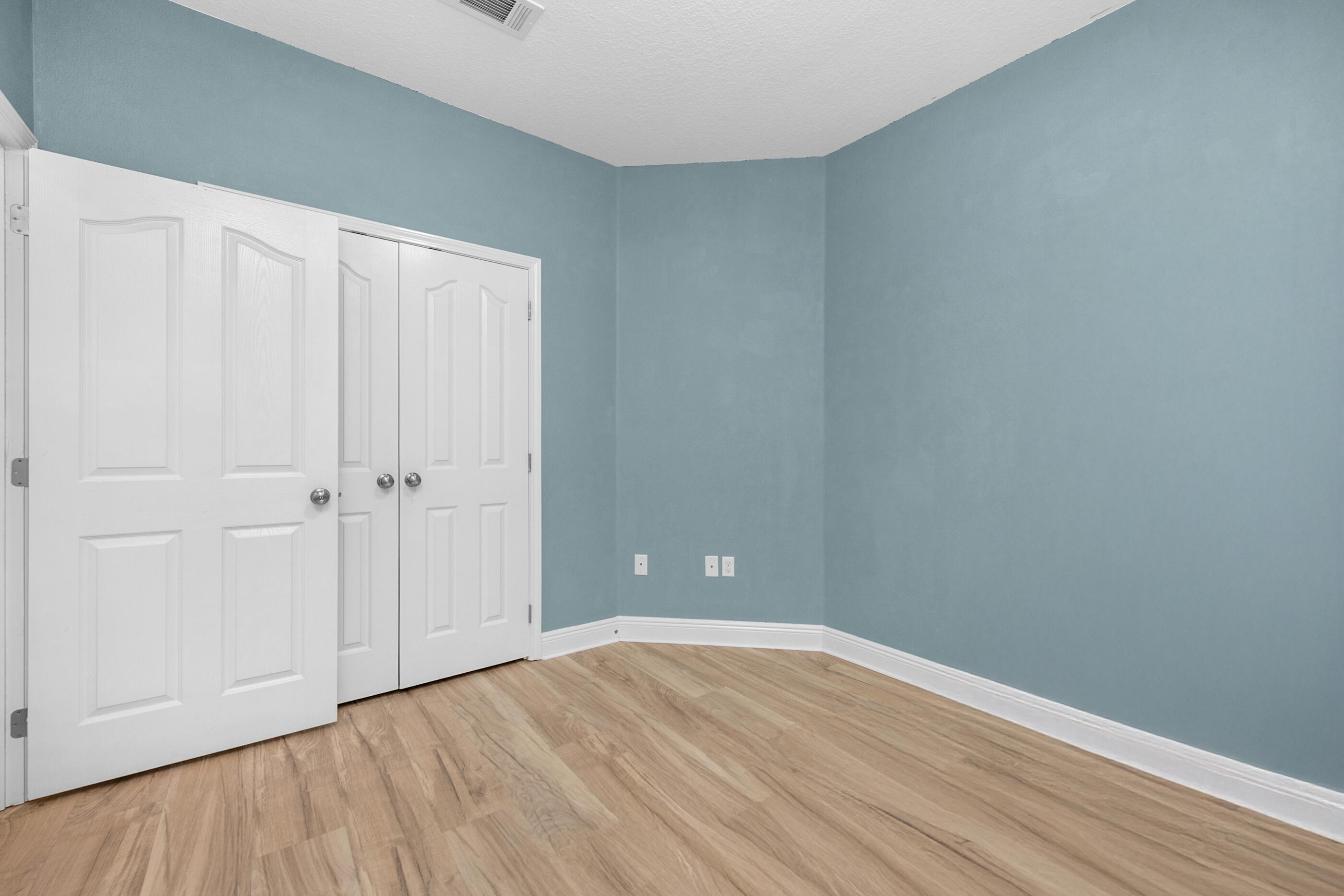 653 Red Fern Road Crestview, FL 32536 - Photo 17 of 34 a view of an empty room with wooden floor
