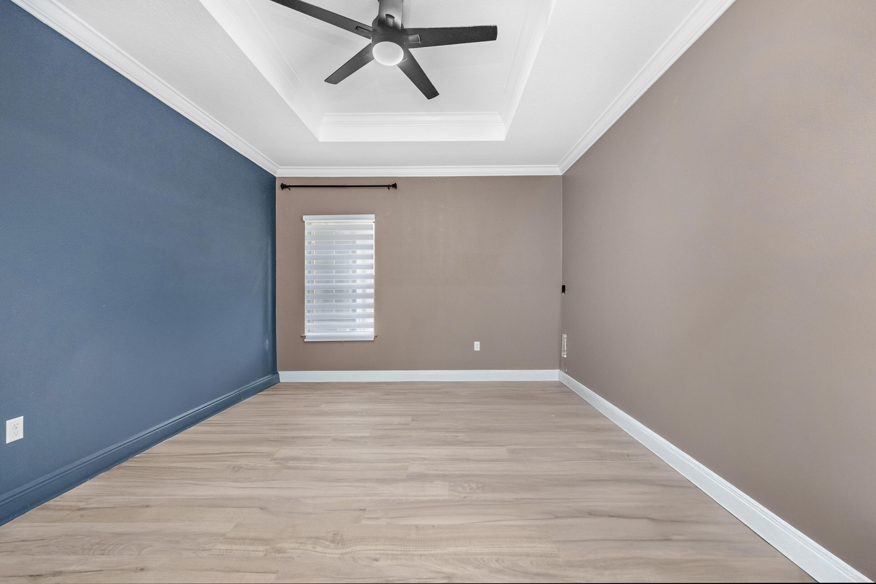 653 Red Fern Road Crestview, FL 32536 - Photo 18 of 34 a view of an empty room with wooden floor and a window