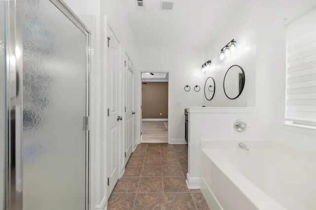 a bathroom with a bathtub a sink and a mirror