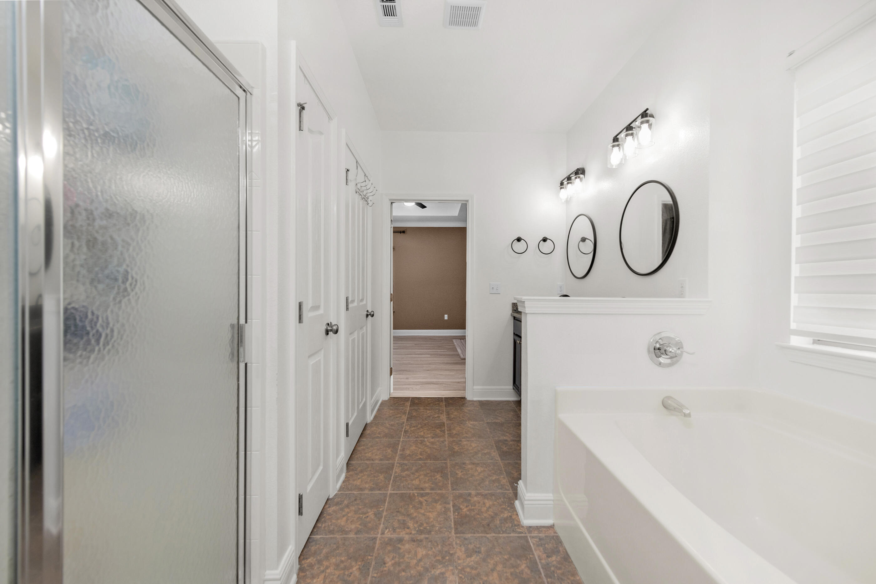 653 Red Fern Road Crestview, FL 32536 - Photo 23 of 34 a bathroom with a bathtub a sink and a mirror