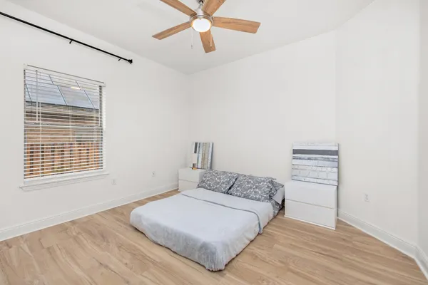 a bedroom with a bed and a night stand