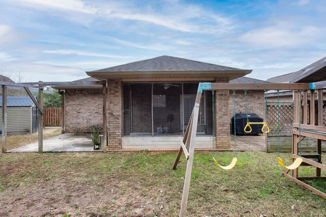 a view of a house with a backyard porch and sitting area