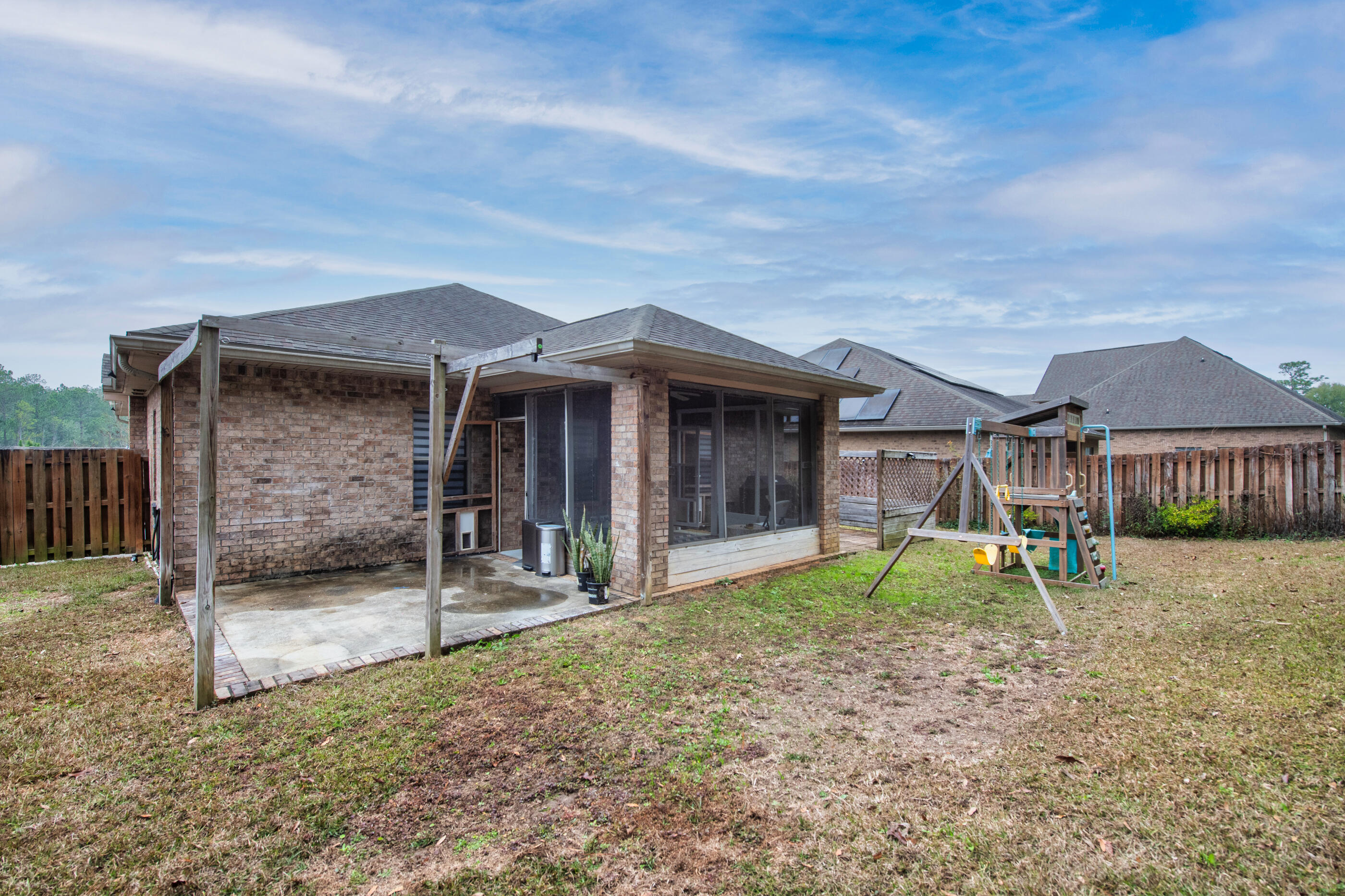 653 Red Fern Road Crestview, FL 32536 - Photo 34 of 34 a backyard of a house with barbeque oven table and chairs