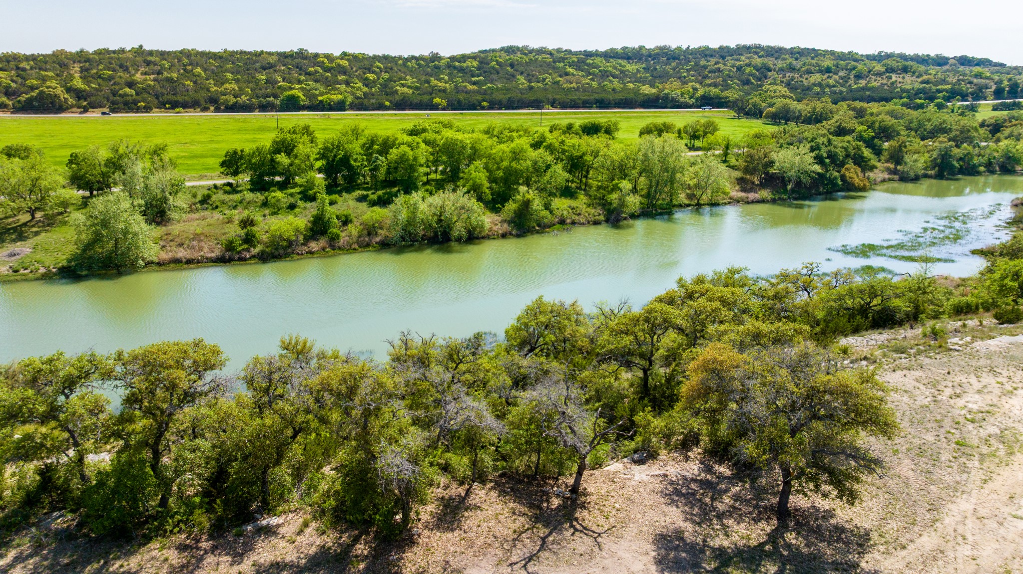 Bird's eye view with a wooded view and a water view