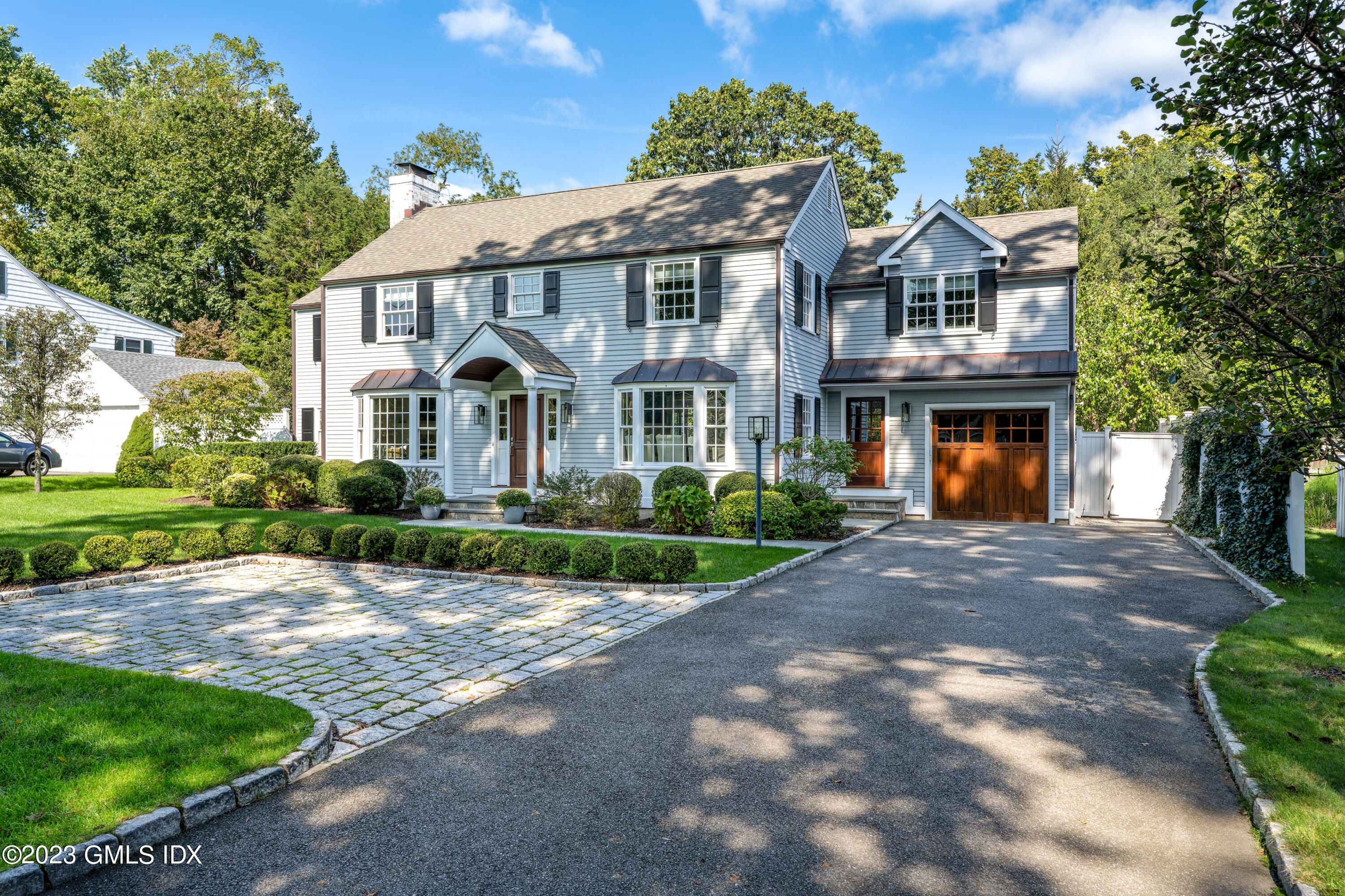 10 Field Road Riverside, CT 06878 - Photo 2 of 18 a front view of a residential houses with yard and green space