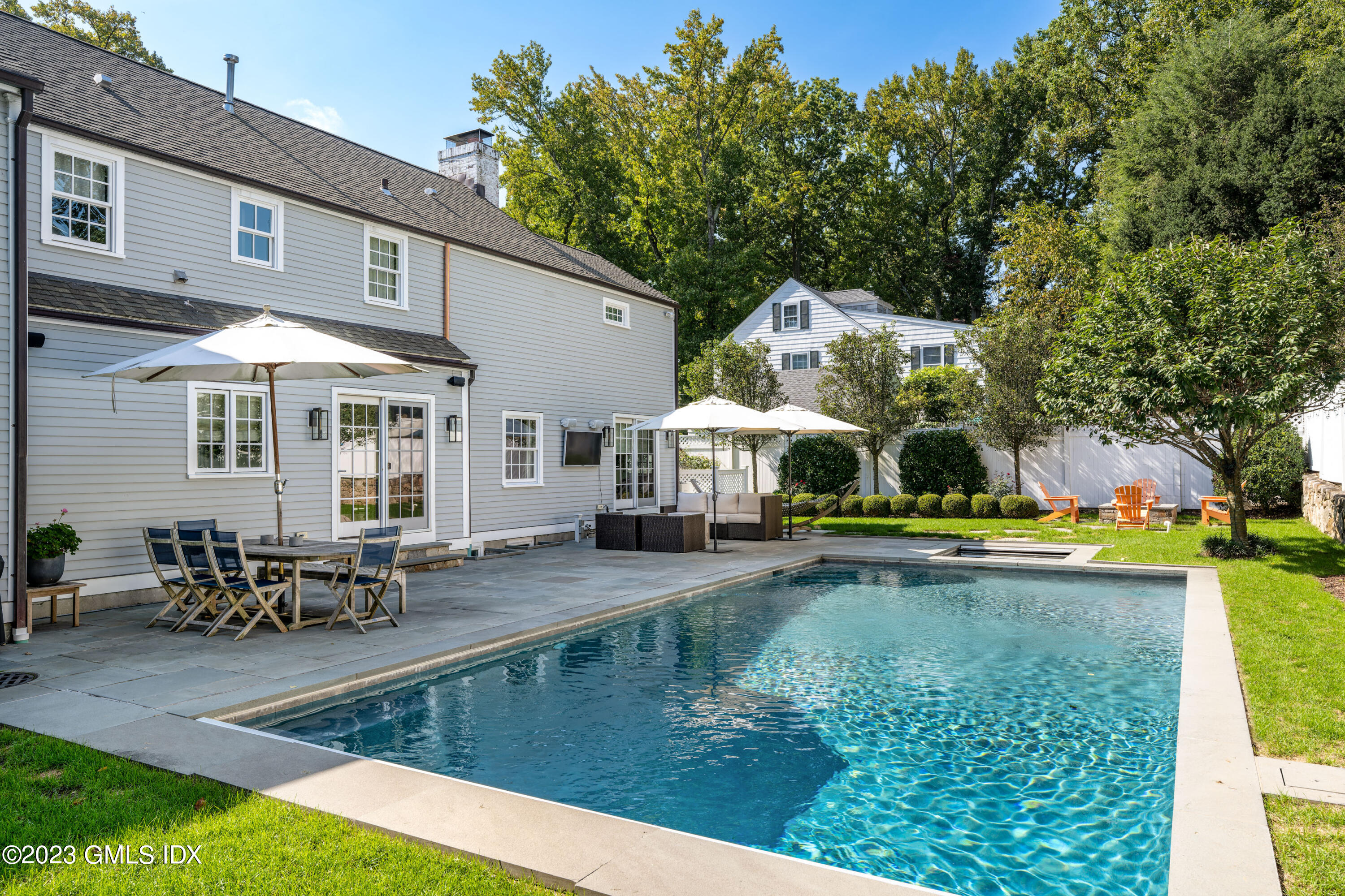 10 Field Road Riverside, CT 06878 - Photo 3 of 18 a swimming pool view with a seating space and a garden view