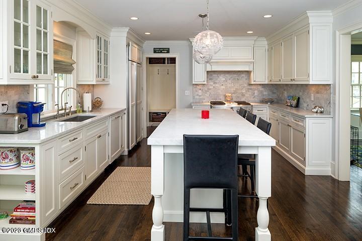 10 Field Road Riverside, CT 06878 - Photo 9 of 18 a kitchen with stainless steel appliances kitchen island granite countertop a stove a sink and a refrigerator