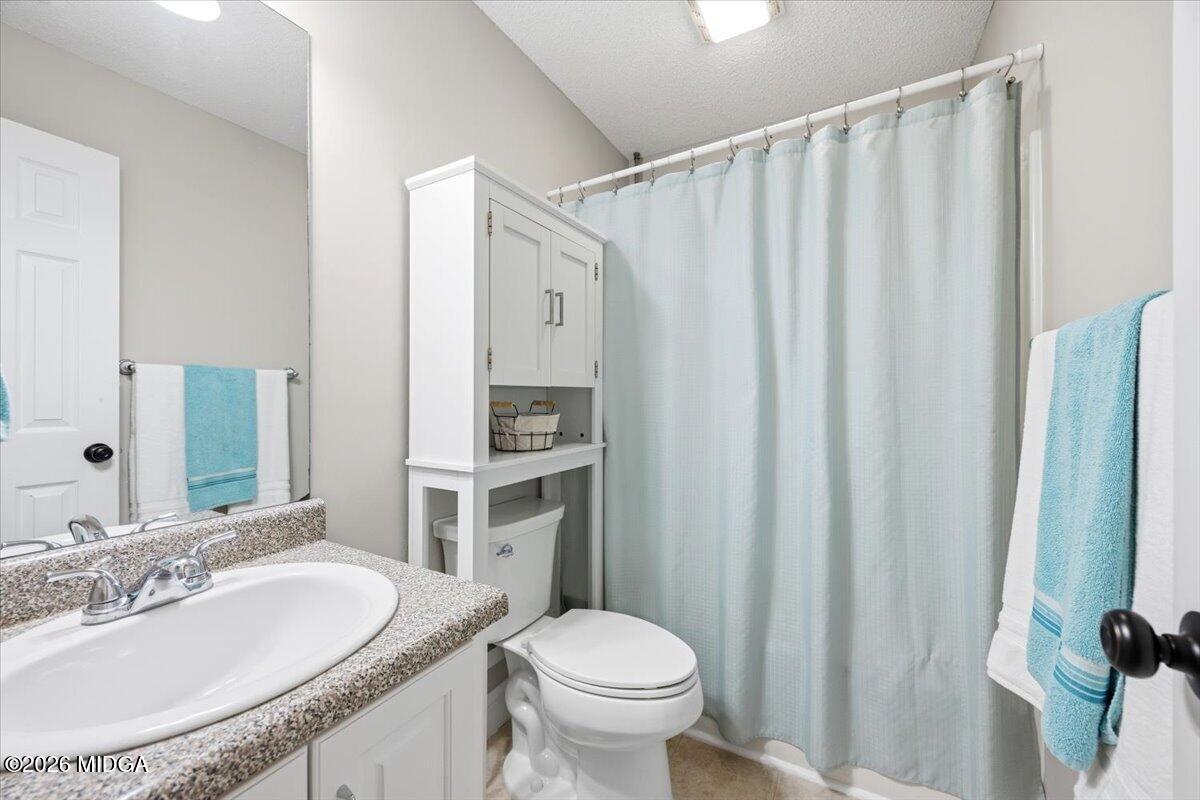 557 Aarons Circle Gray, GA 31032 - Photo 23 of 36 a bathroom with a granite countertop sink toilet and a mirror