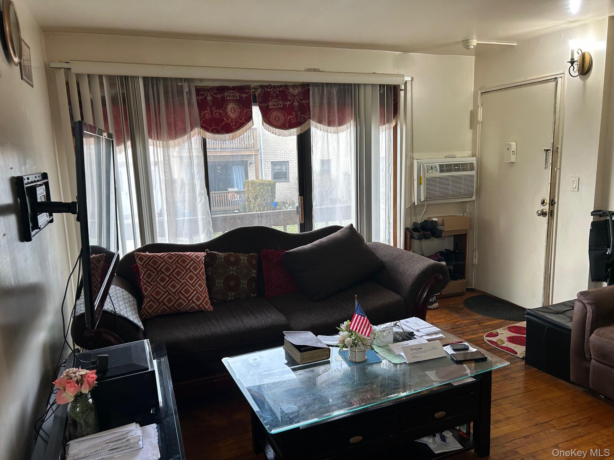 17 Sneden Place West, Unit 17 Spring Valley, NY 10977 - Photo 14 of 29 Living area with dark wood finished floors and a wall mounted AC