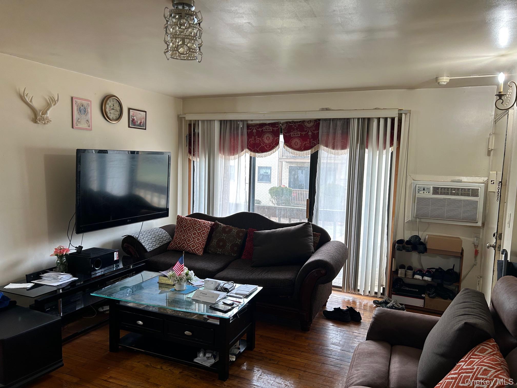 17 Sneden Place West, Unit 17 Spring Valley, NY 10977 - Photo 8 of 29 Living room with wood-type flooring and a wall mounted air conditioner