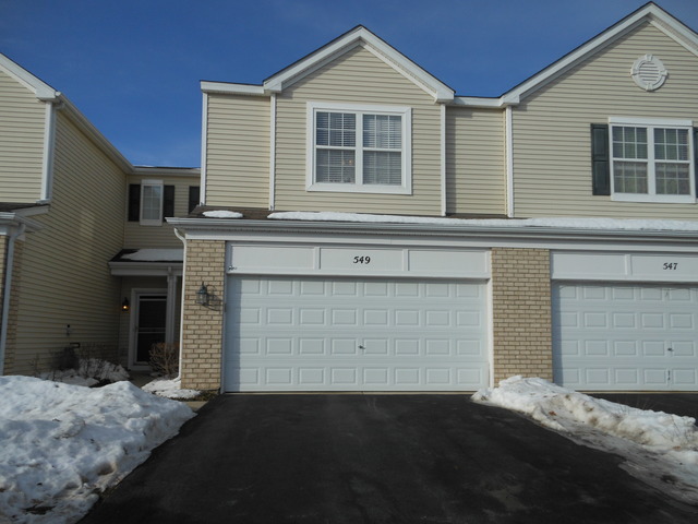 549 Springbrook Trail North Oswego, IL 60543 - Photo 1 of 19 a front view of a house with a yard and garage