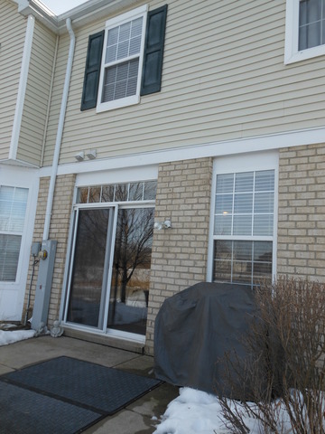 549 Springbrook Trail North Oswego, IL 60543 - Photo 19 of 19 a backyard of a house with barbeque oven and outdoor seating