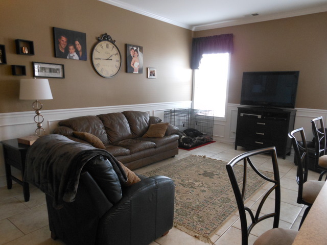 549 Springbrook Trail North Oswego, IL 60543 - Photo 3 of 19 a living room with furniture and a flat screen tv