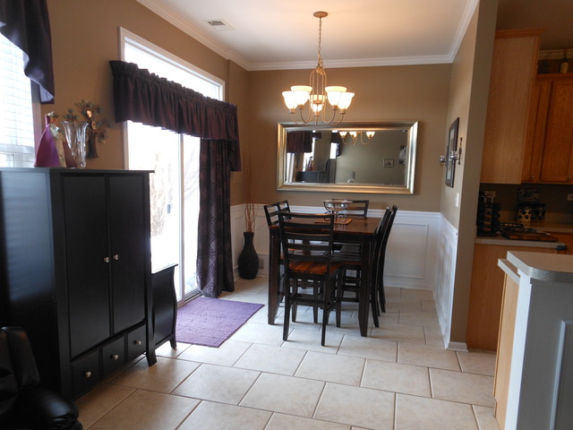 549 Springbrook Trail North Oswego, IL 60543 - Photo 4 of 19 a view of a dining room with furniture and chandelier