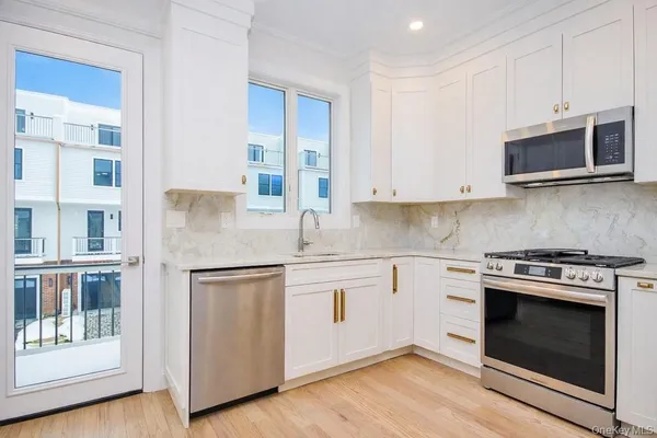 a kitchen with stainless steel appliances a sink and a refrigerator