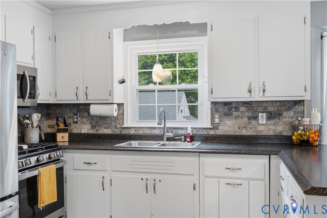 20108 Eugene Drive Sutherland, VA 23885 - Photo 11 of 41 a kitchen with stainless steel appliances granite countertop white cabinets and a window